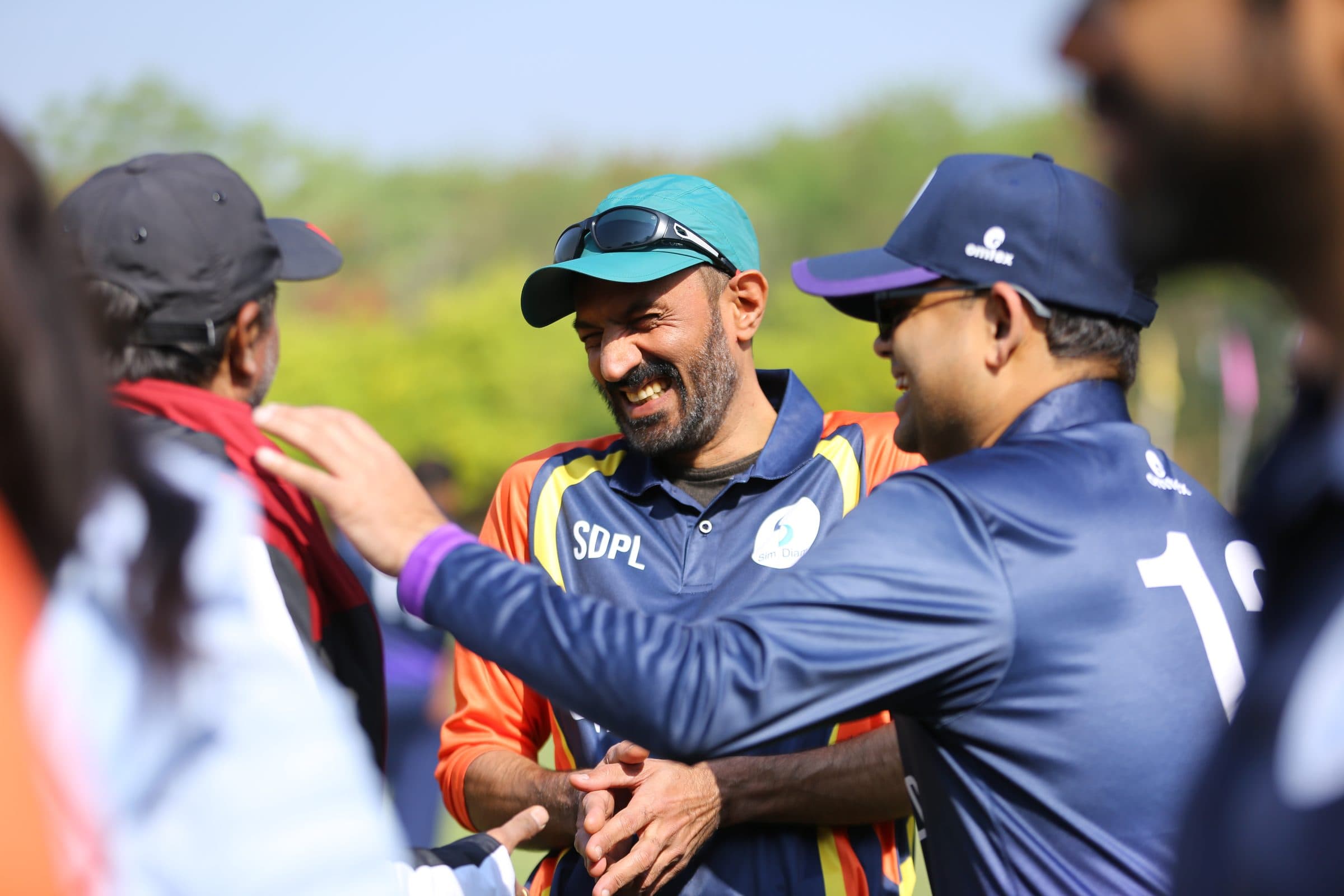 Two teams laughing together before play