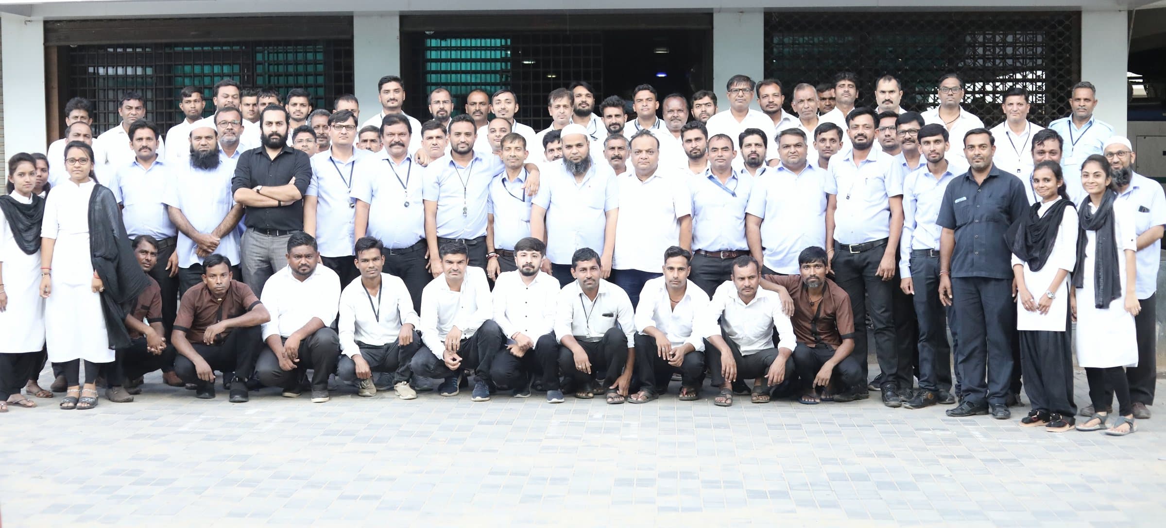 The full factory team in front of the manufacturing unit